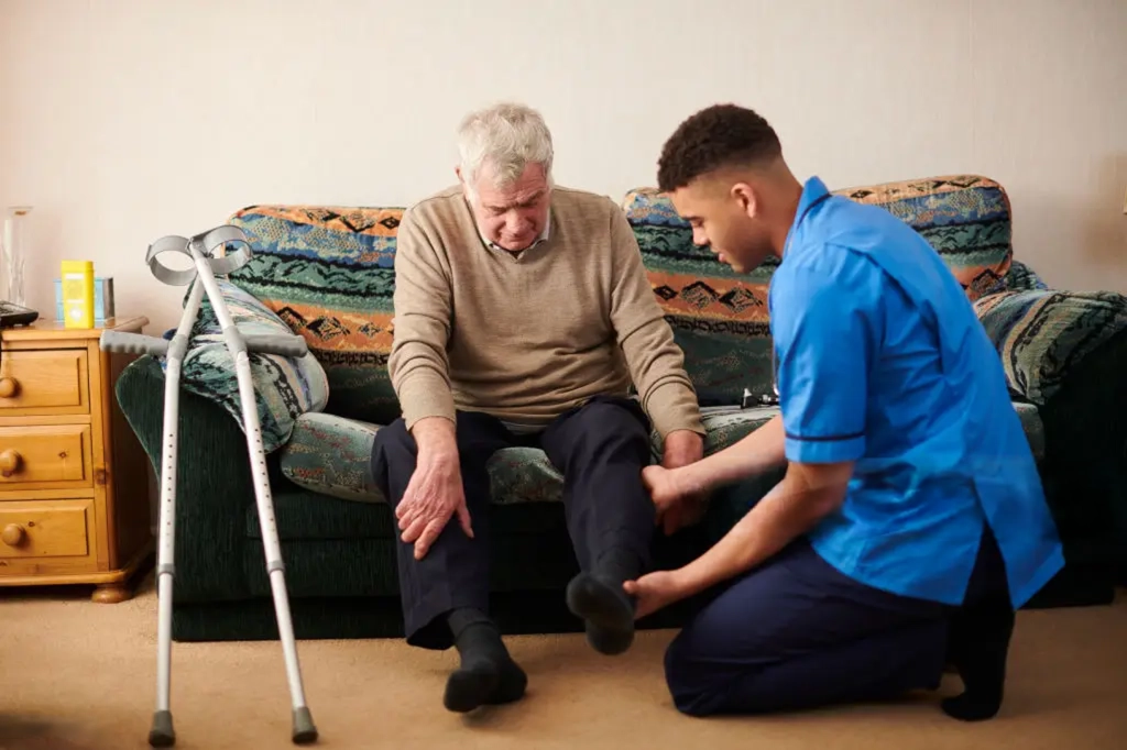 A Reliance Homecare nurse attending to an elderly client